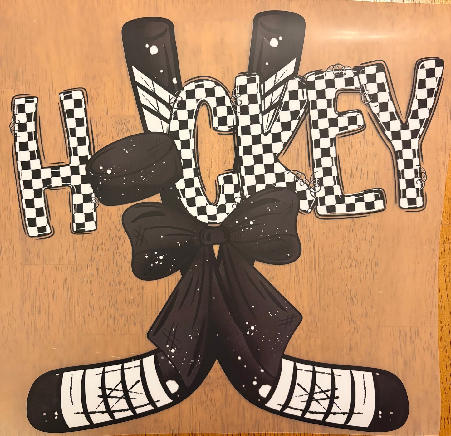 "Hockey puck and bow"